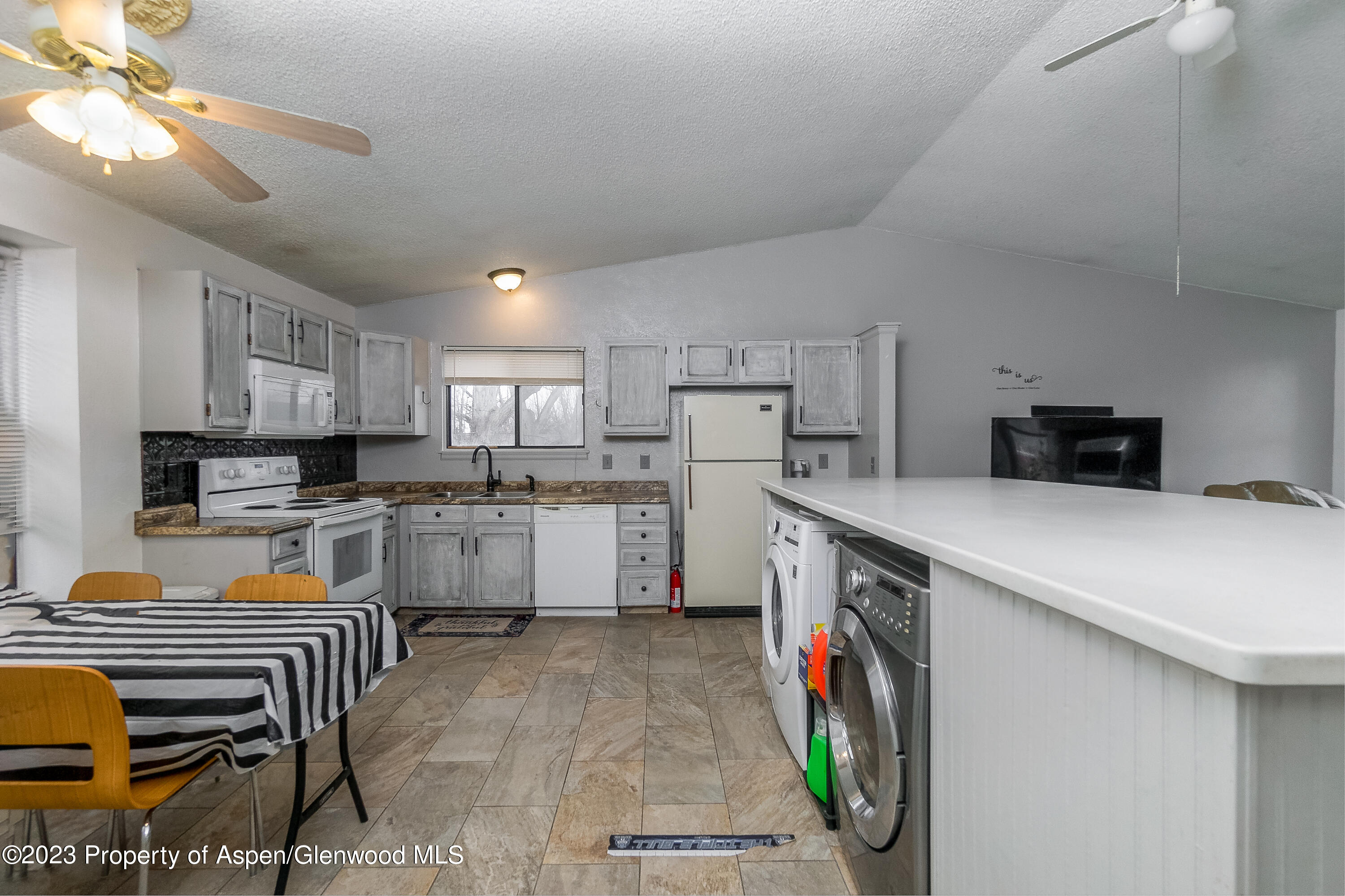 51 Hackberry Lane Parachute, CO 81635 - Photo 8 of 17 a kitchen that has a lot of cabinets a sink and a stove in it