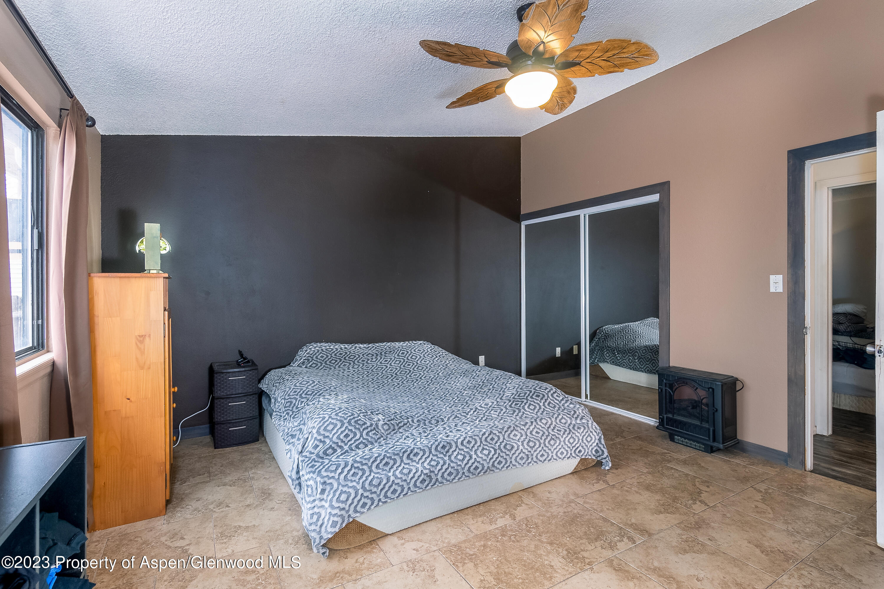 51 Hackberry Lane Parachute, CO 81635 - Photo 10 of 17 a spacious bedroom with a bed and a chandelier