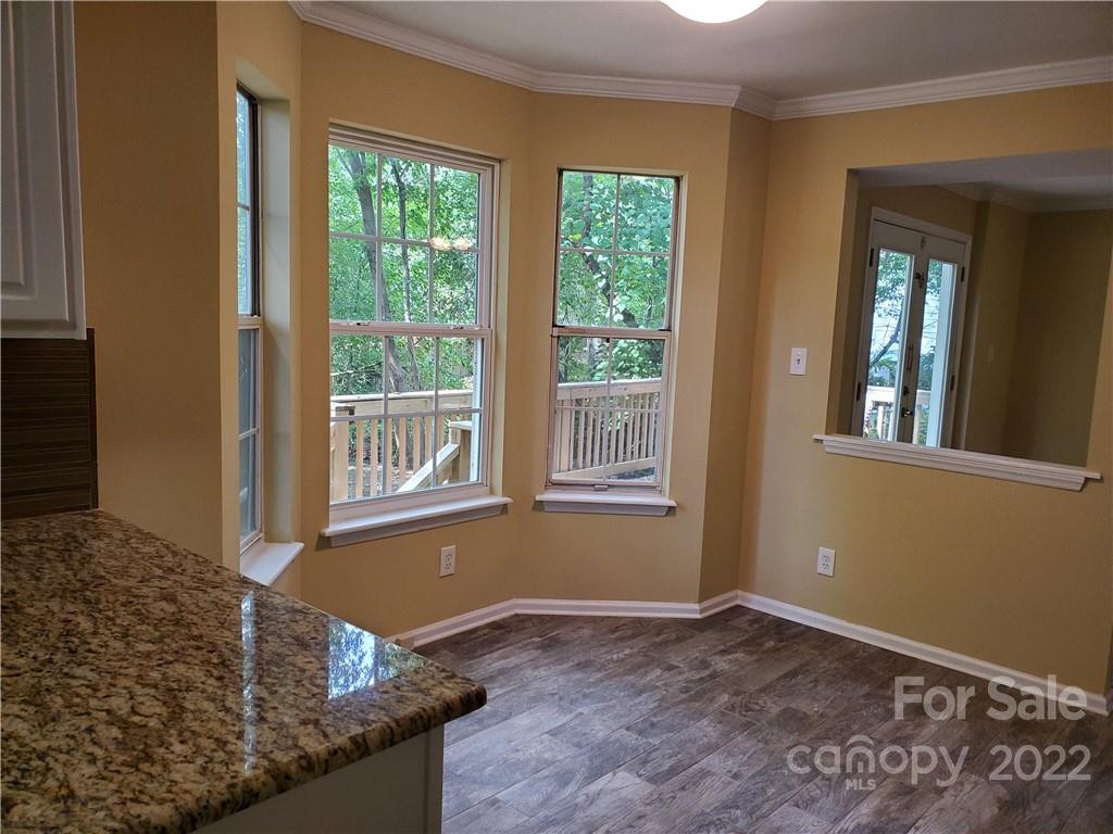8919 Vicksburg Road Charlotte, NC 28227 - Photo 11 of 22 a view of an empty room with wooden floor and a window