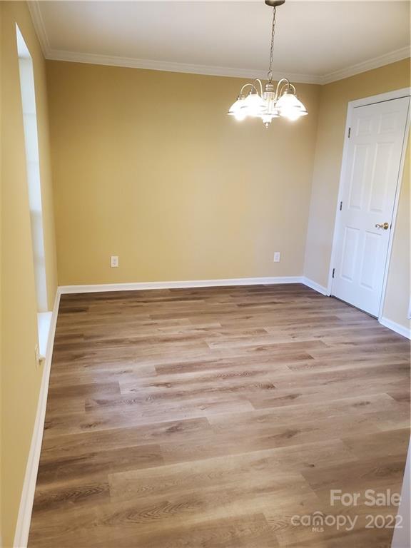 8919 Vicksburg Road Charlotte, NC 28227 - Photo 13 of 22 a view of an empty room with wooden floor and a window