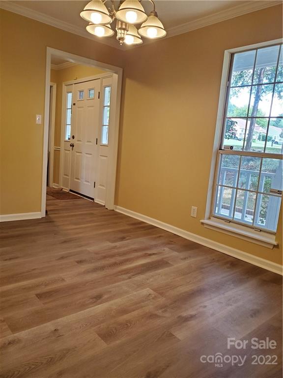 8919 Vicksburg Road Charlotte, NC 28227 - Photo 7 of 22 an empty room with wooden floor and windows