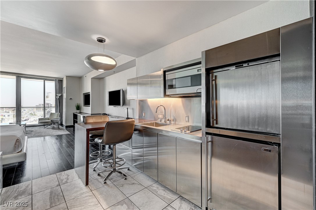 4381 West Flamingo Road, Unit 3206 Las Vegas, NV 89103 - Photo 30 of 30 Kitchen with a sink, stainless steel appliances, light countertops, modern cabinets, and open floor plan