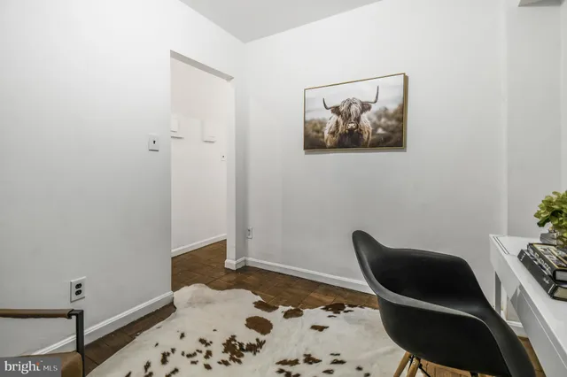 a living room with a rug and a chair