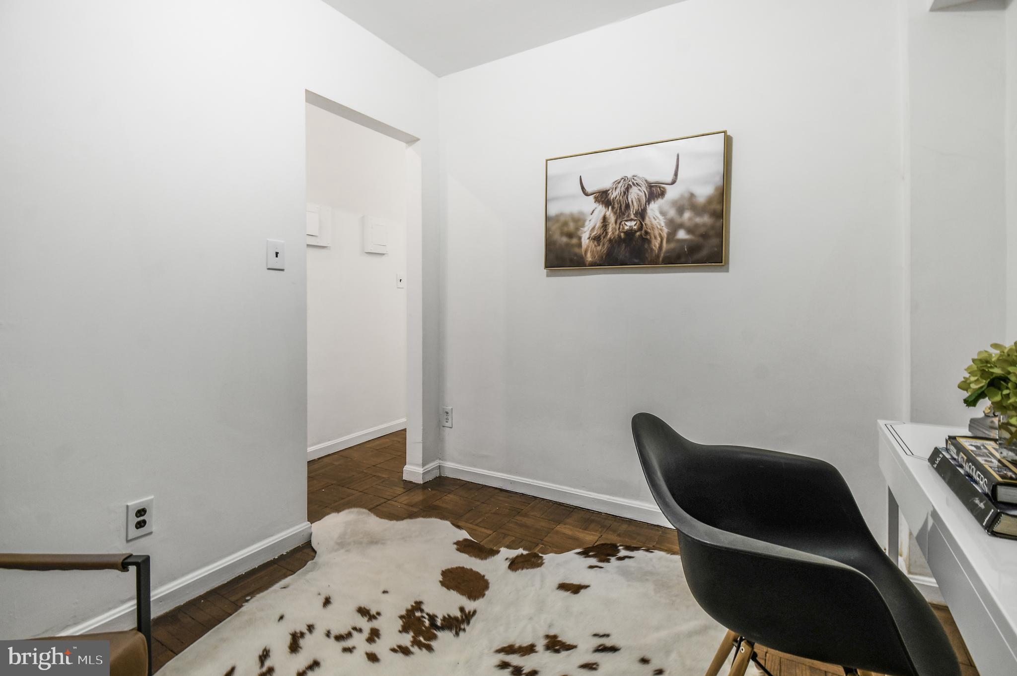 3701 Connecticut Avenue Northwest, Unit 236 Washington, DC 20008 - Photo 11 of 19 a living room with a rug and a chair
