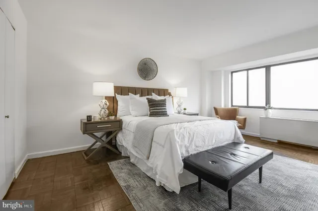 a bedroom with a bed and a window