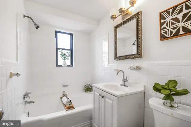 a bathroom with a sink a mirror and a bathtub