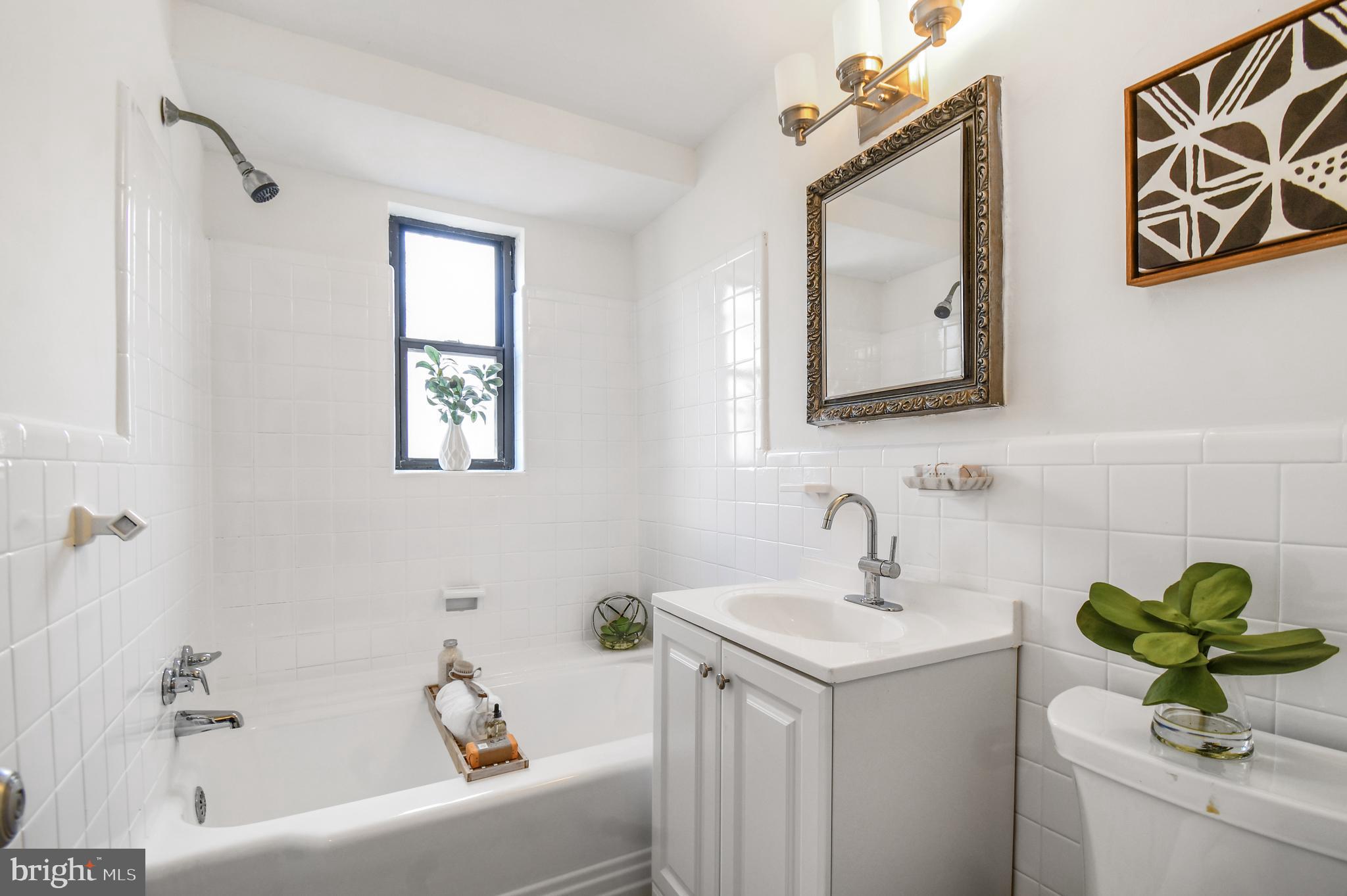 3701 Connecticut Avenue Northwest, Unit 236 Washington, DC 20008 - Photo 17 of 19 a bathroom with a sink a mirror and a bathtub