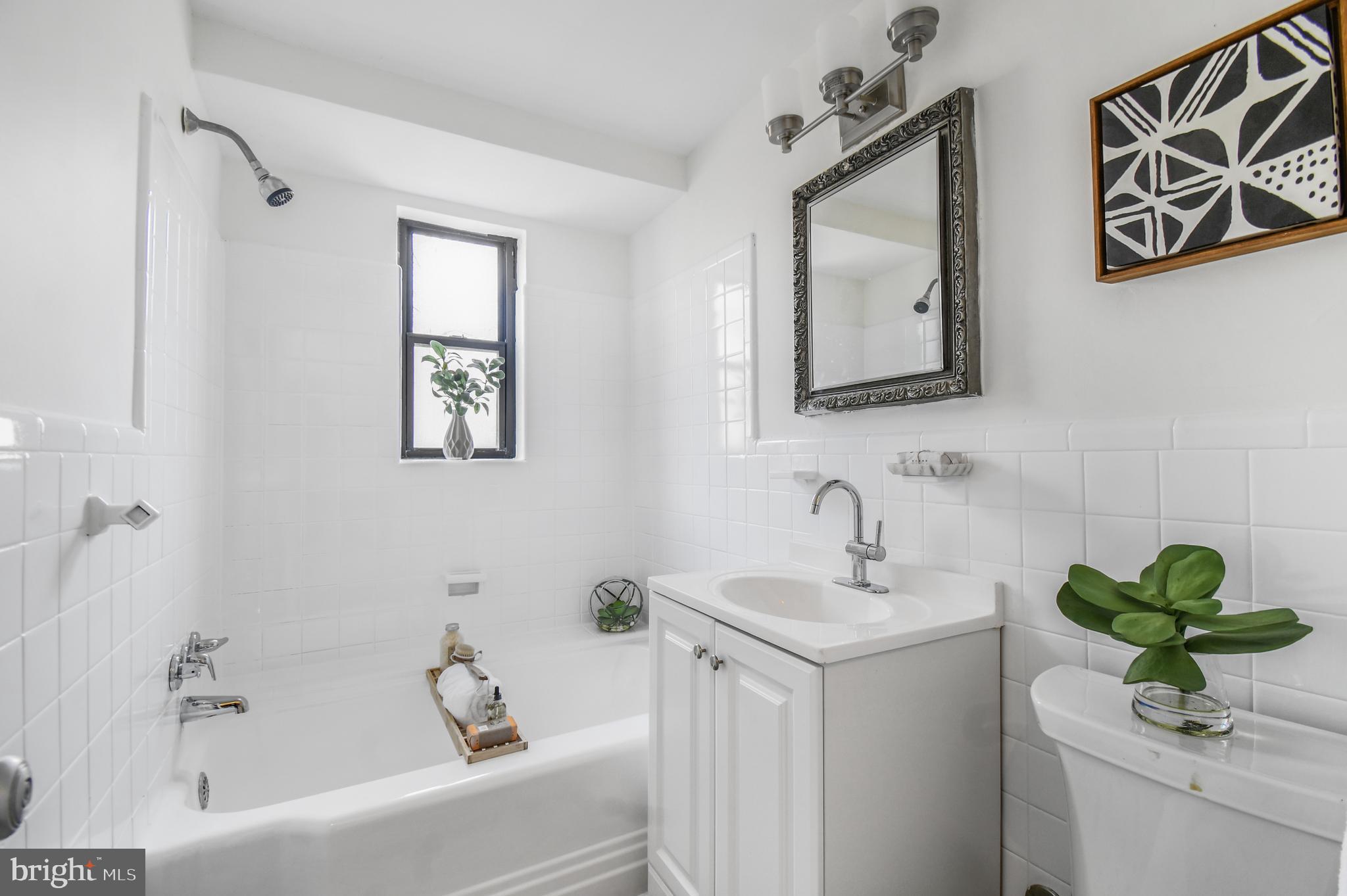 3701 Connecticut Avenue Northwest, Unit 236 Washington, DC 20008 - Photo 18 of 19 a bathroom with a sink a mirror and a bathtub