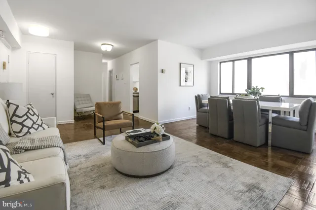 a living room with furniture and large windows