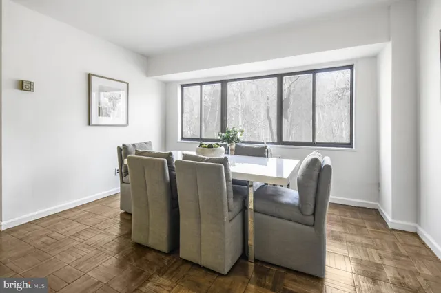 a view of kitchen with stainless steel appliances granite countertop cabinets and a dining table