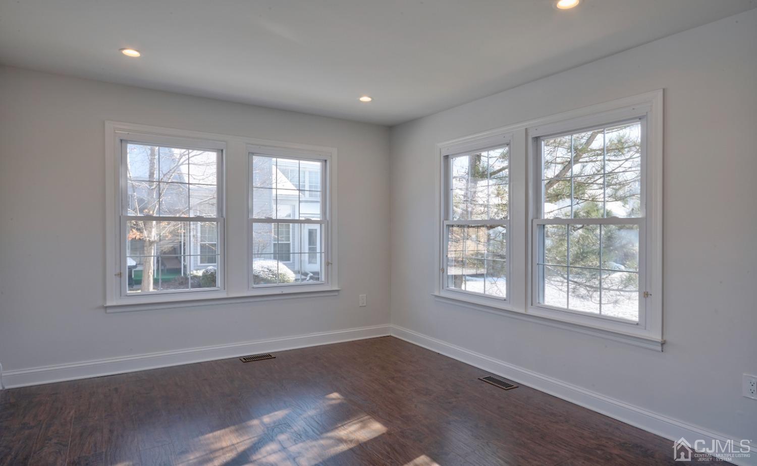 5 Cottingham Drive Monroe Township, NJ 08831 - Photo 11 of 19 an empty room with wooden floor and windows