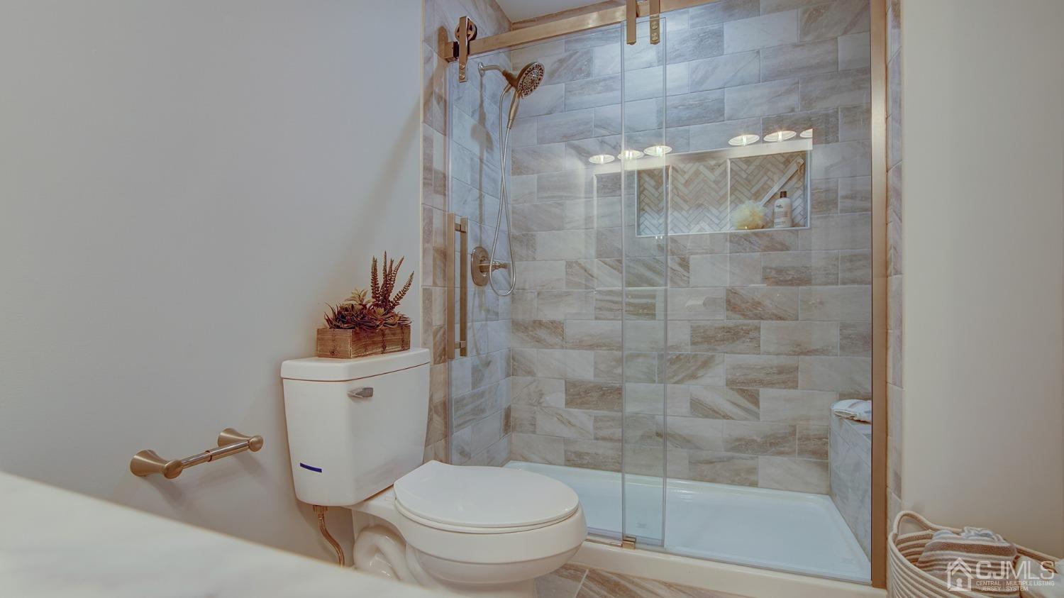 5 Cottingham Drive Monroe Township, NJ 08831 - Photo 13 of 19 a white toilet next to a bathroom sink