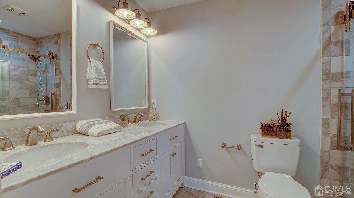 5 Cottingham Drive Monroe Township, NJ 08831 - Photo 14 of 19 a bathroom with a granite countertop sink mirror vanity and toilet