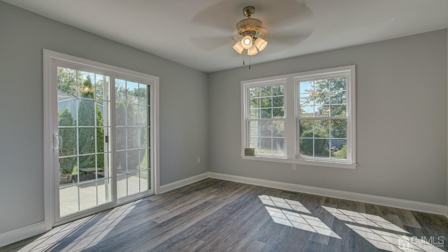 5 Cottingham Drive Monroe Township, NJ 08831 - Photo 15 of 19 a view of an empty room with a window and wooden floor