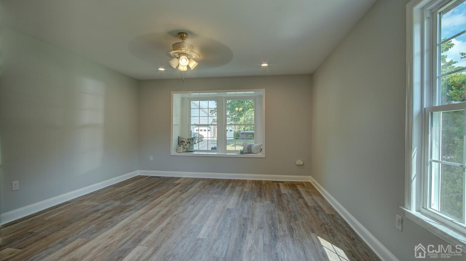 5 Cottingham Drive Monroe Township, NJ 08831 - Photo 16 of 19 an empty room with wooden floor and windows