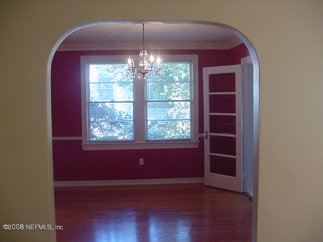 4144 London Road Jacksonville, FL 32207 - Photo 4 of 15 an empty room with wooden floor and windows