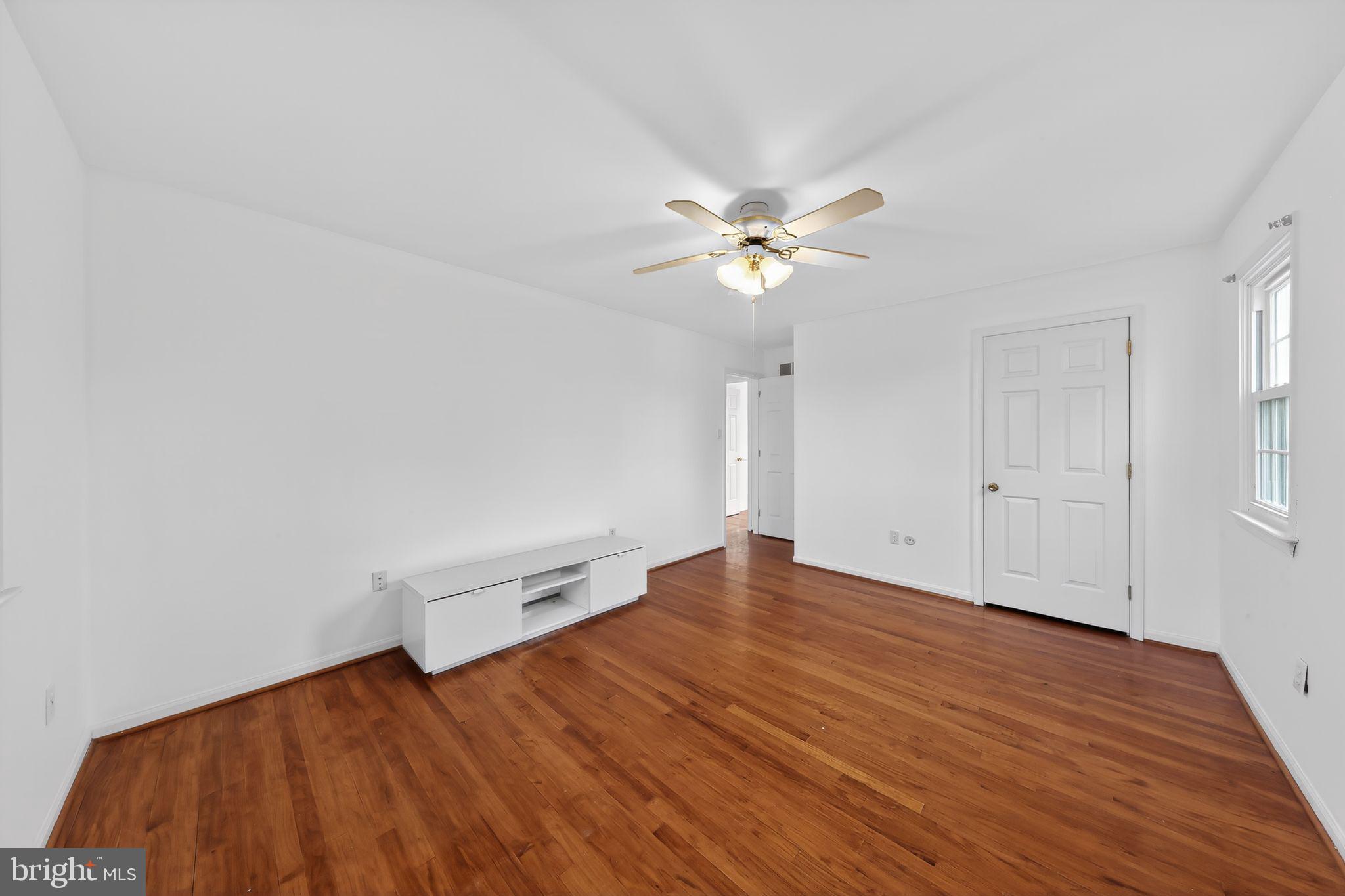 6 Kings Grant Road Hockessin, DE 19707 - Photo 18 of 24 an empty room with wooden floor and windows