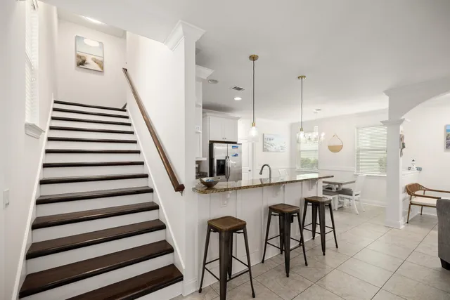 a kitchen with stainless steel appliances granite countertop a sink a stove and a refrigerator