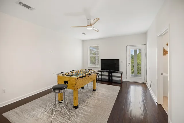 a view of a swimming pool with a chair and palm trees