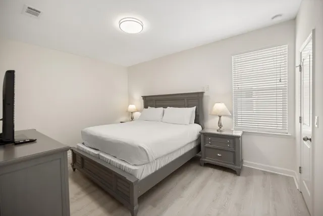 a view of a patio with a table and chairs under an umbrella