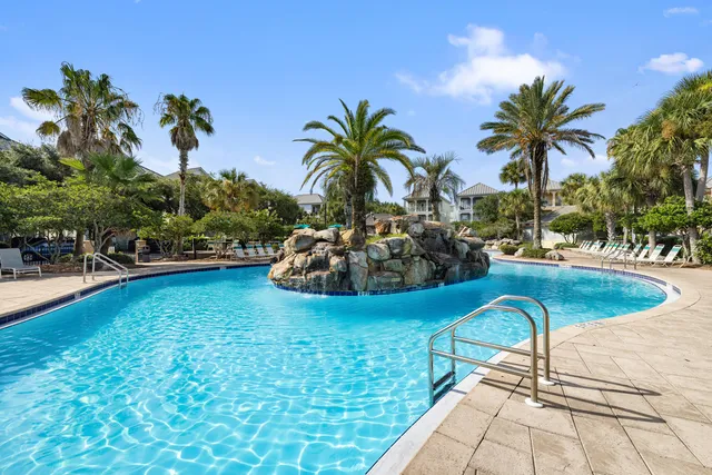 a front view of a house with a tree