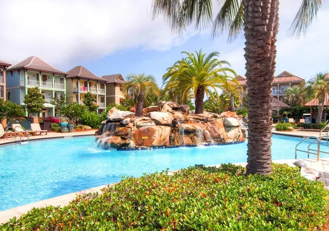 a kitchen with a refrigerator a sink and chairs
