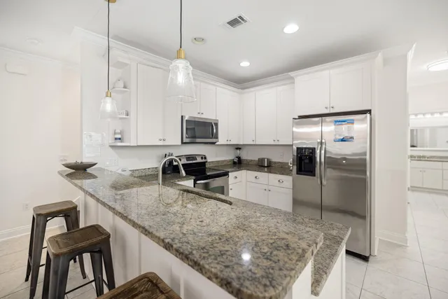 a kitchen with a stove and a refrigerator