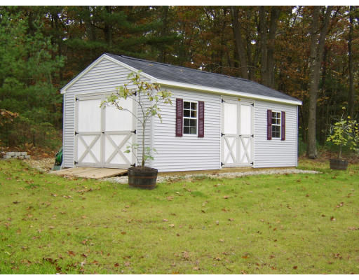 98 Coffey Hill Road Ware, MA 01082 - Photo 9 of 9 a backyard of a white house with potted plants and a yard