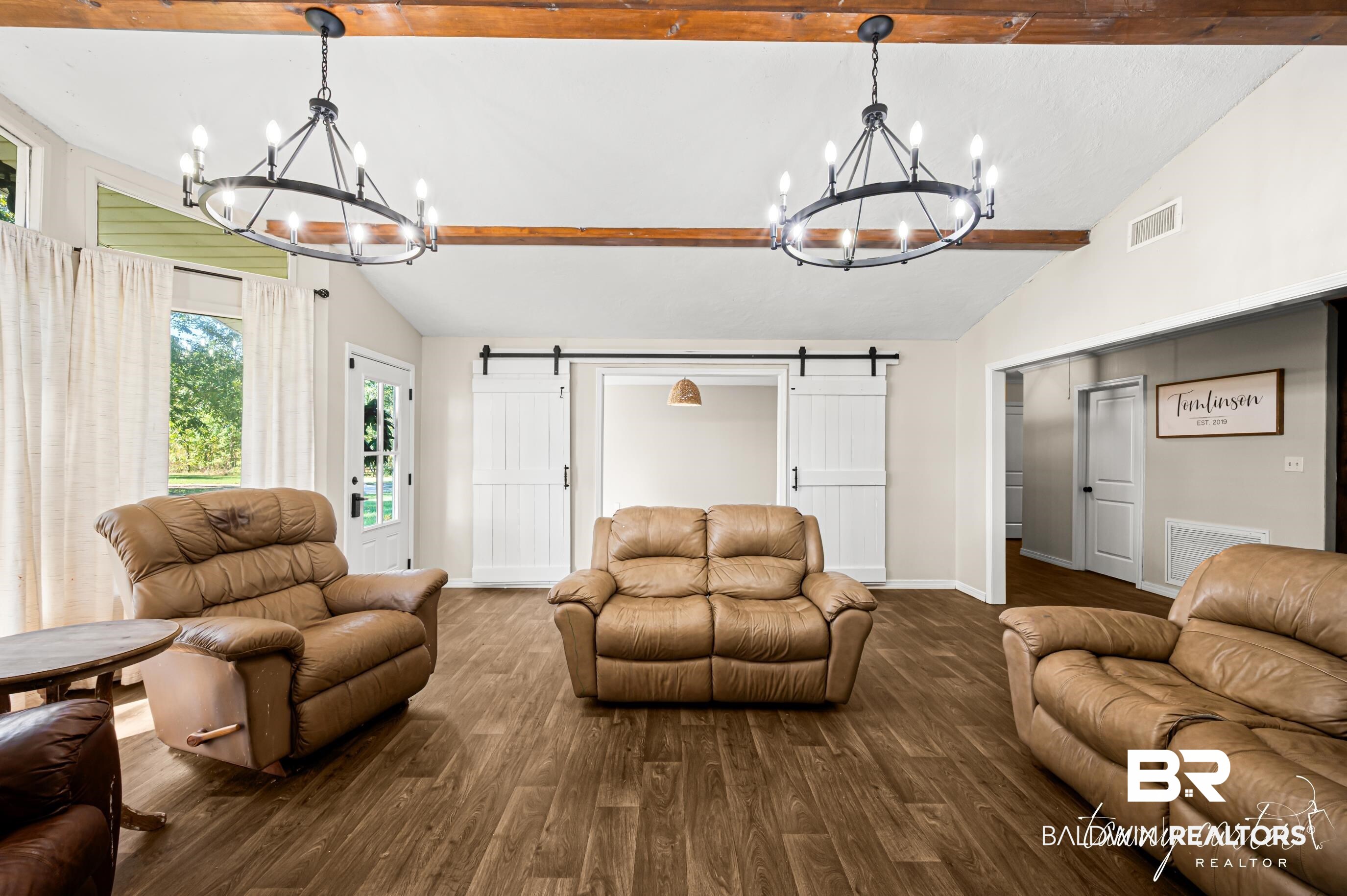 3086 Wild Fork Road Frisco City, AL 36445 - Photo 6 of 30 Living room with a barn door, wood finished floors, and a chandelier