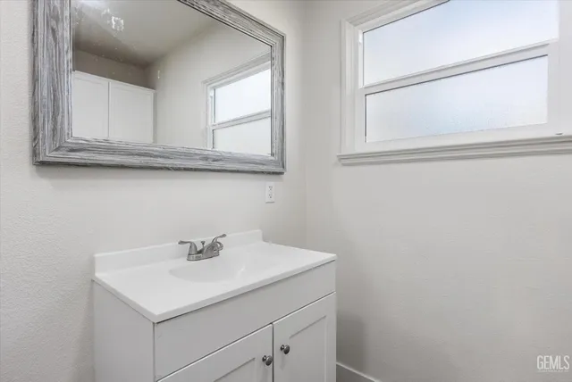 a bathroom with a sink and a window