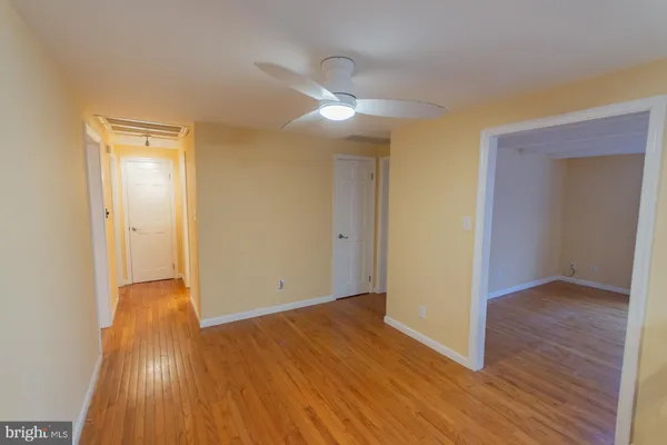 a view of a room with wooden floor