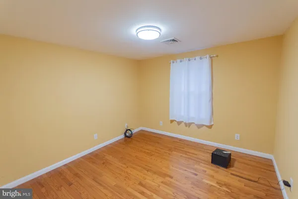 a view of a room with wooden walls and a window