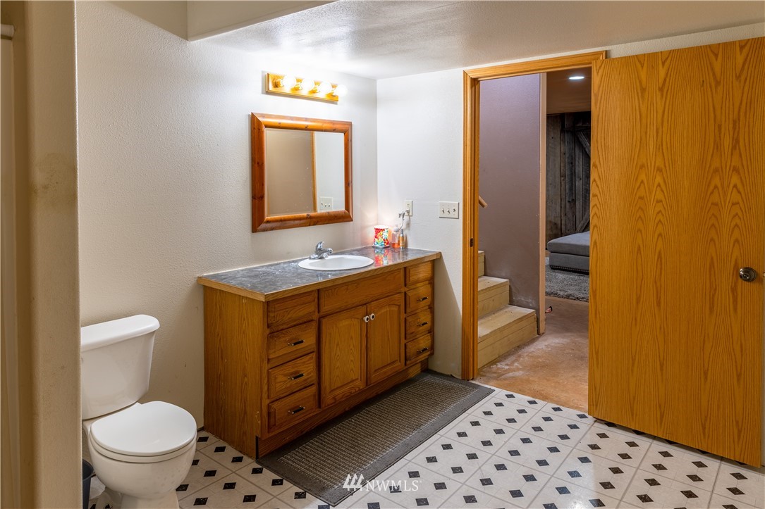 345 Seylor Valley Road Inchelium, WA 99138 - Photo 15 of 28 a bathroom with a sink a toilet and mirror