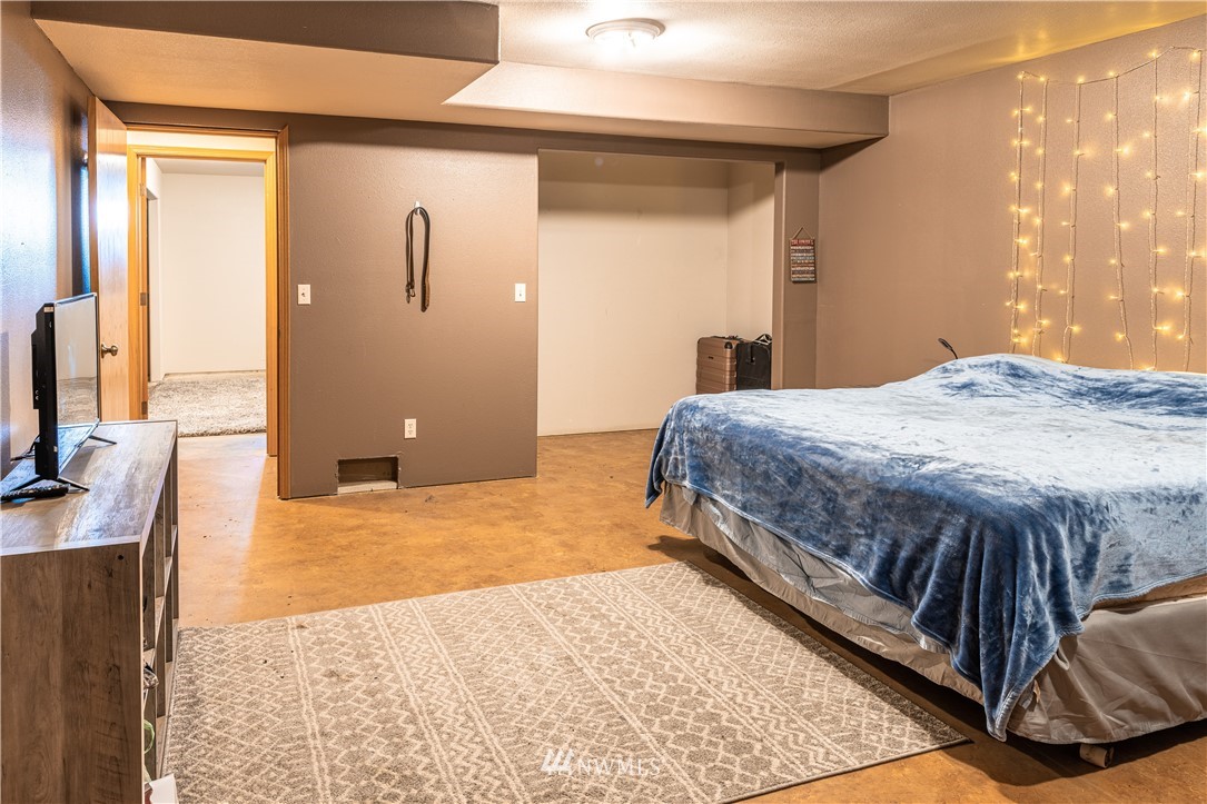 345 Seylor Valley Road Inchelium, WA 99138 - Photo 16 of 28 a bedroom with a bed and a flat screen tv