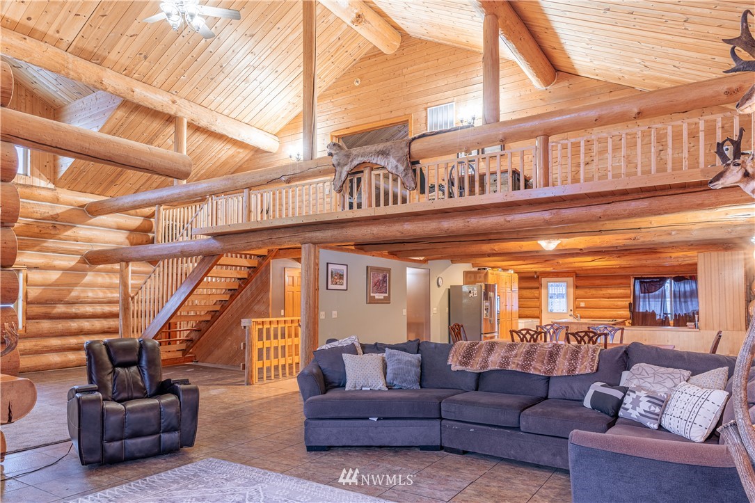 345 Seylor Valley Road Inchelium, WA 99138 - Photo 3 of 28 a living room with furniture a ceiling fan and a large window