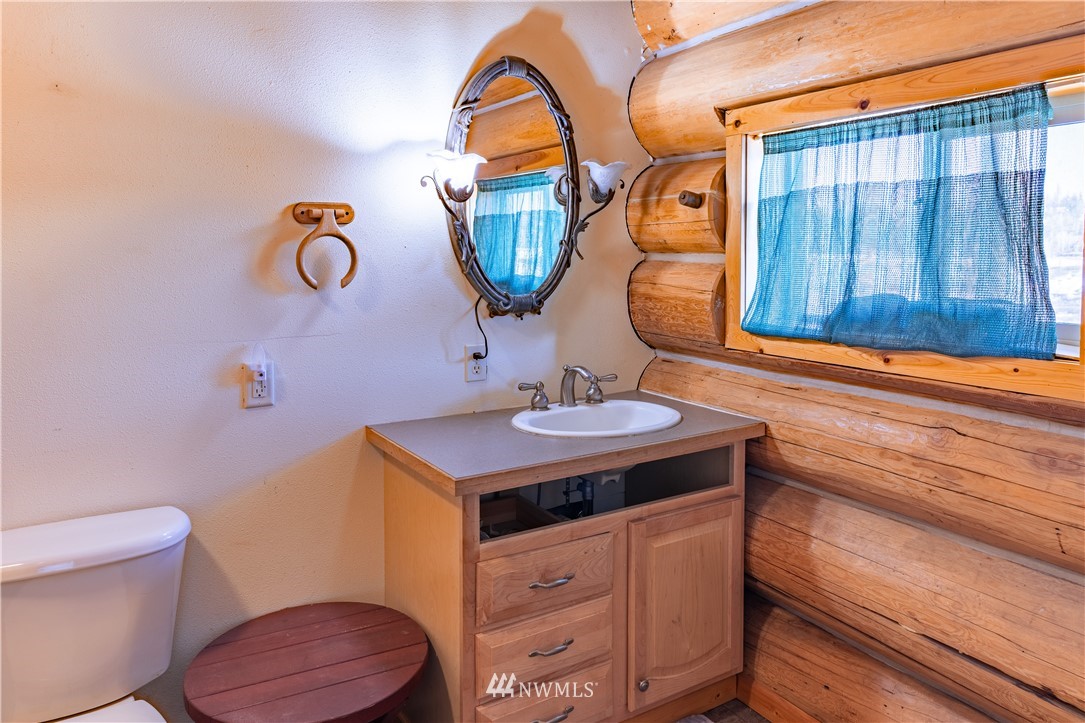 345 Seylor Valley Road Inchelium, WA 99138 - Photo 9 of 28 a bathroom with a sink a mirror and toilet