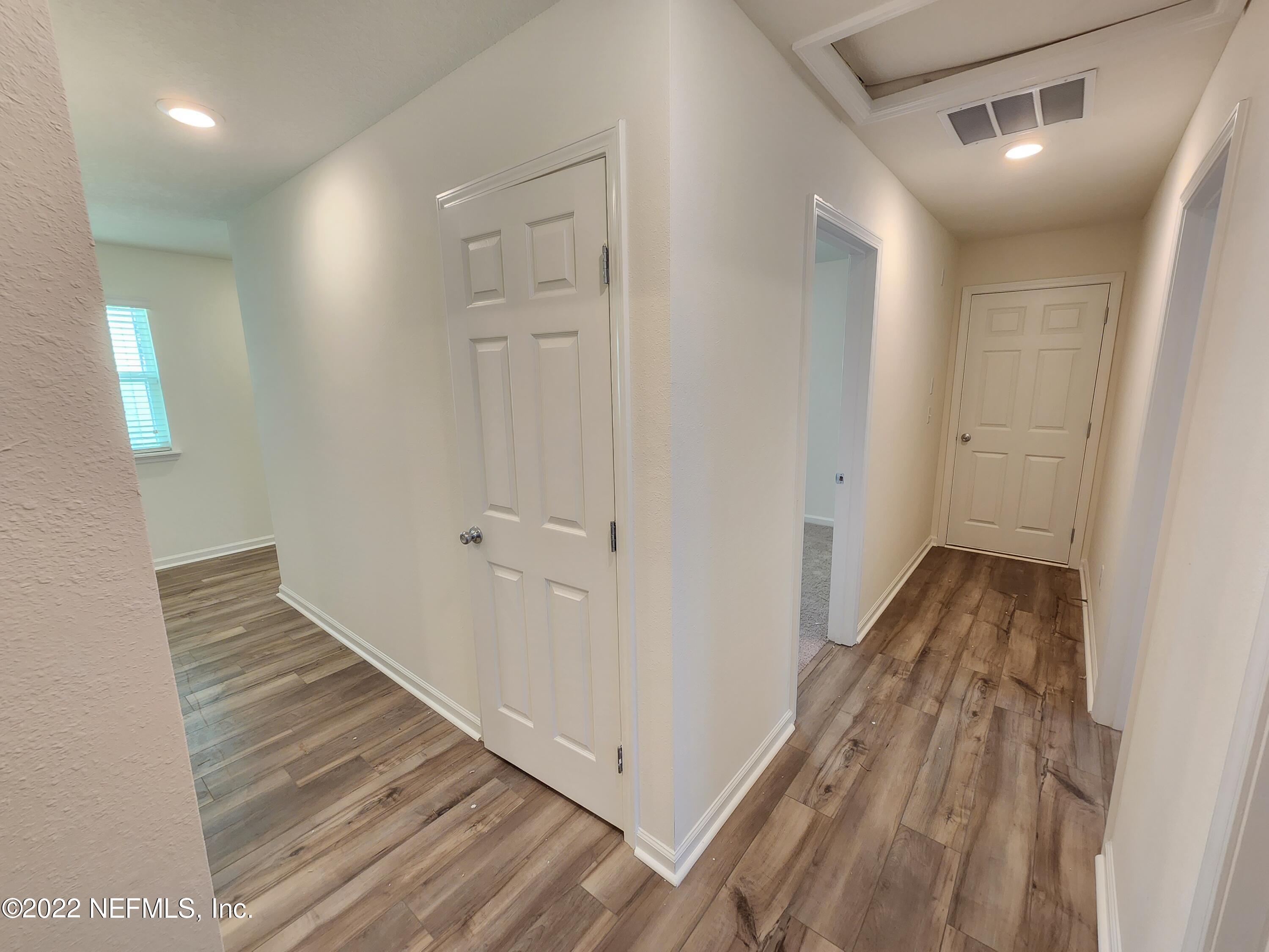 3035 Lucille Lane Middleburg, FL 32068 - Photo 13 of 39 a view of a hallway with wooden floor and staircase