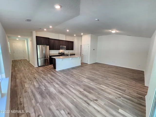a view of walk in closet with an empty room