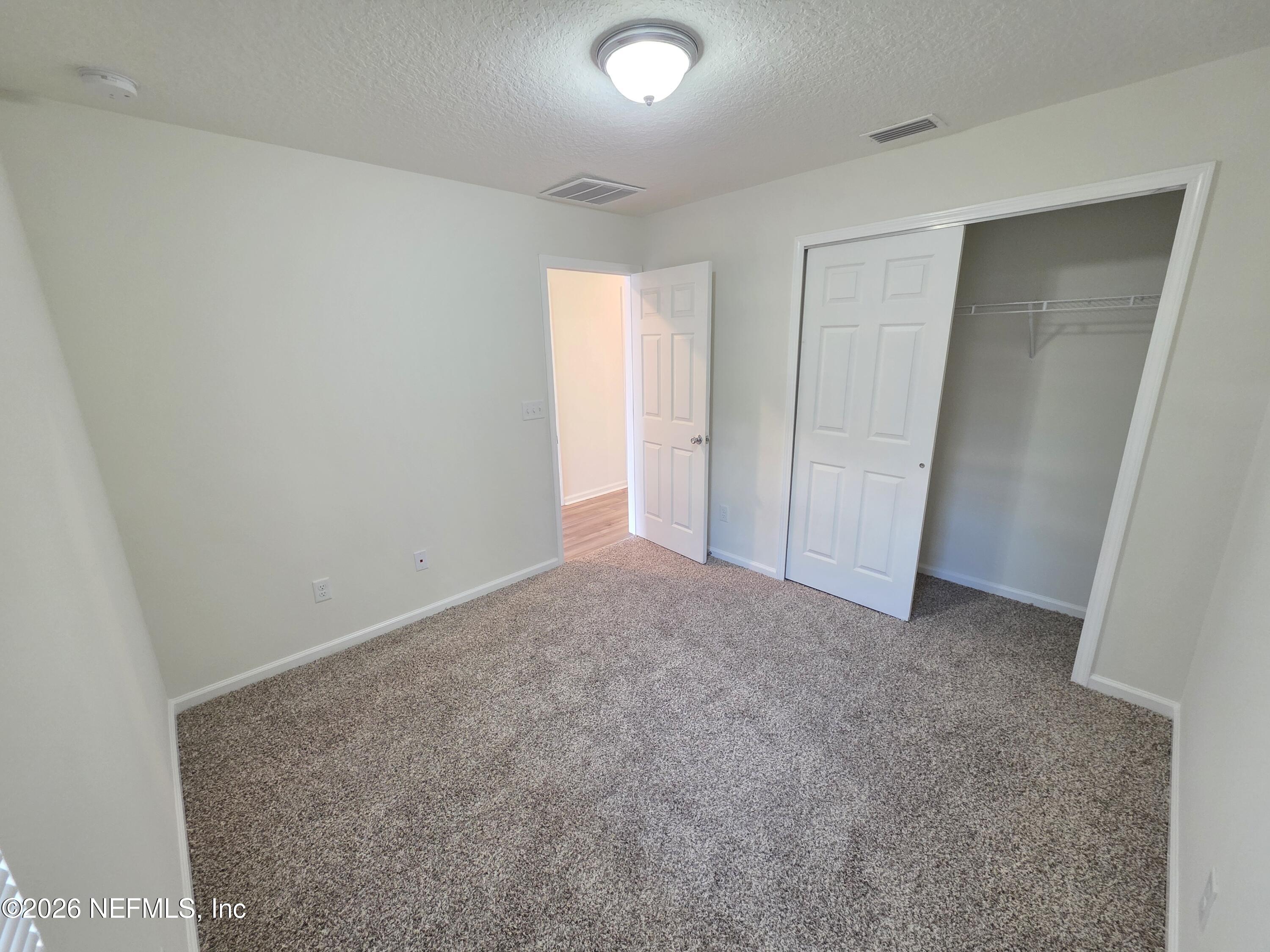3035 Lucille Lane Middleburg, FL 32068 - Photo 18 of 39 an empty room with windows and closet