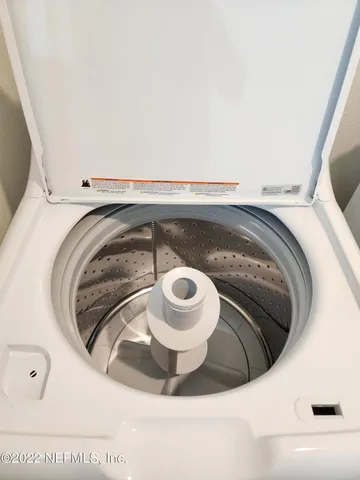 a view of a big room with closet and windows