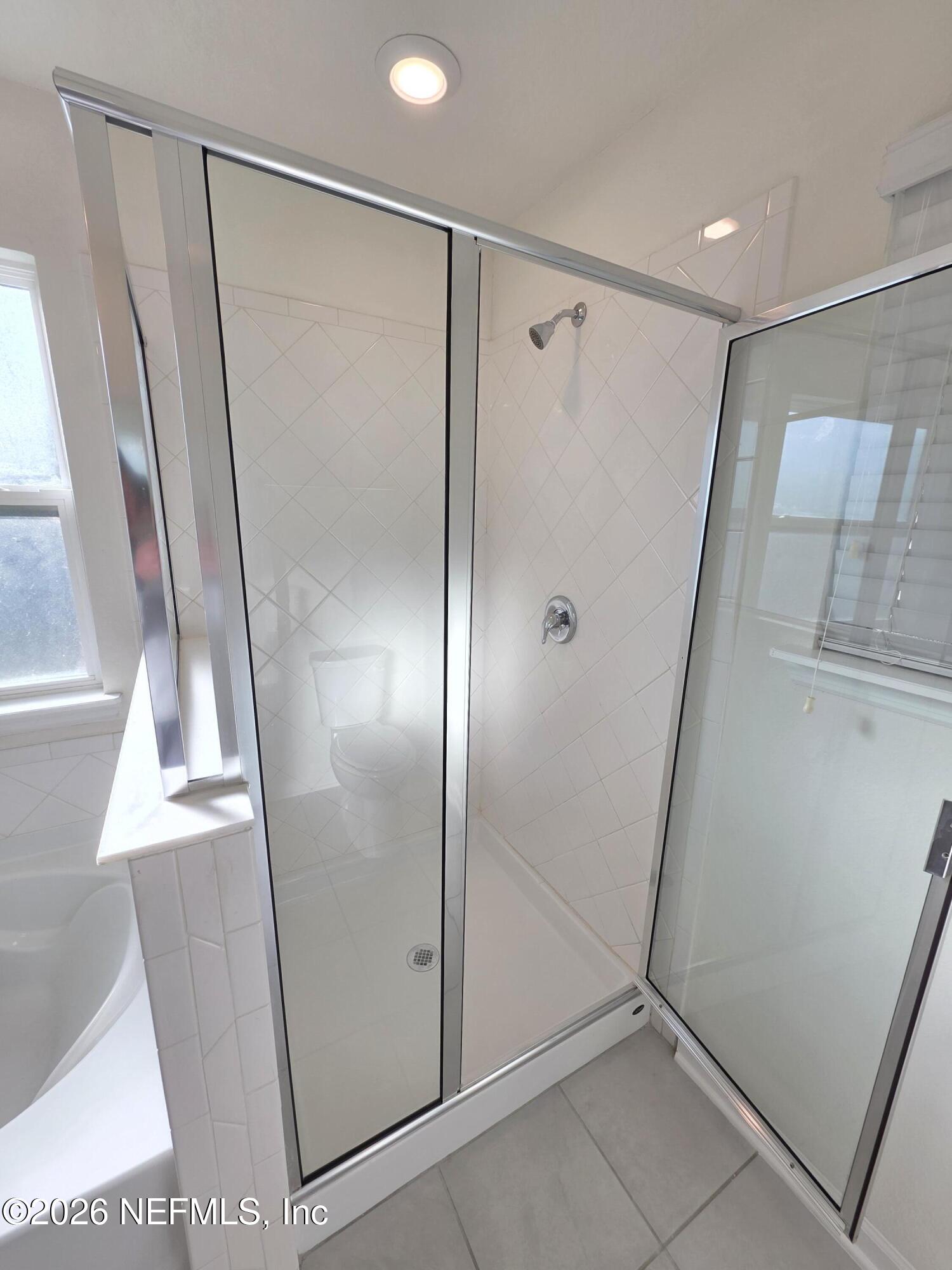 3035 Lucille Lane Middleburg, FL 32068 - Photo 31 of 39 a bathroom with a glass door shower and a sink