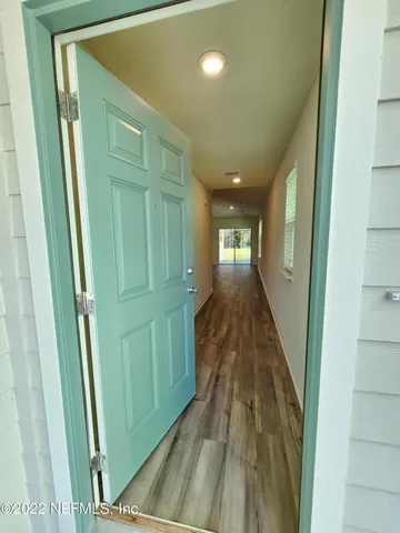 a view of gallery with wooden floor