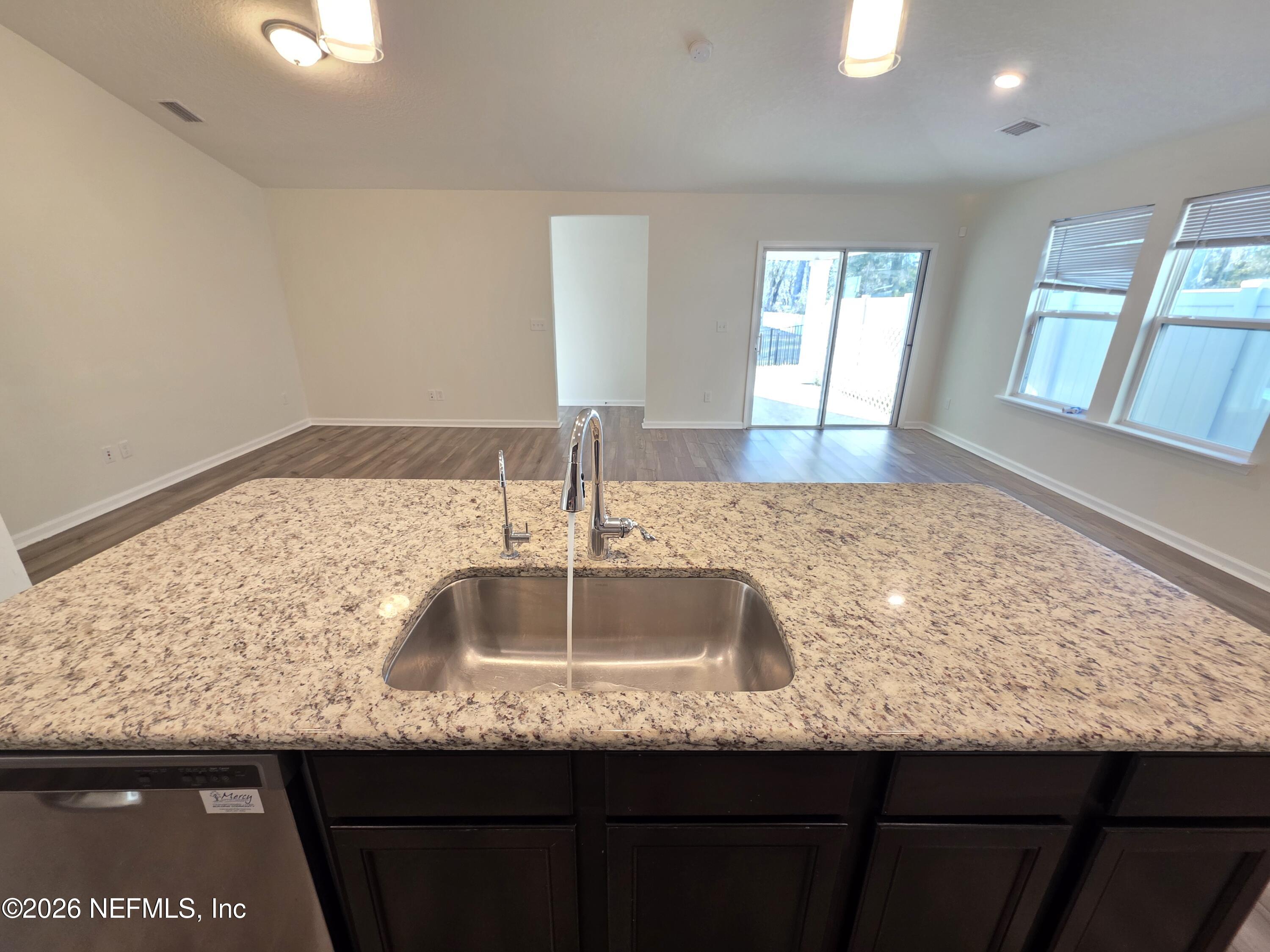 3035 Lucille Lane Middleburg, FL 32068 - Photo 9 of 39 a kitchen with granite countertop kitchen island a sink with wooden floor