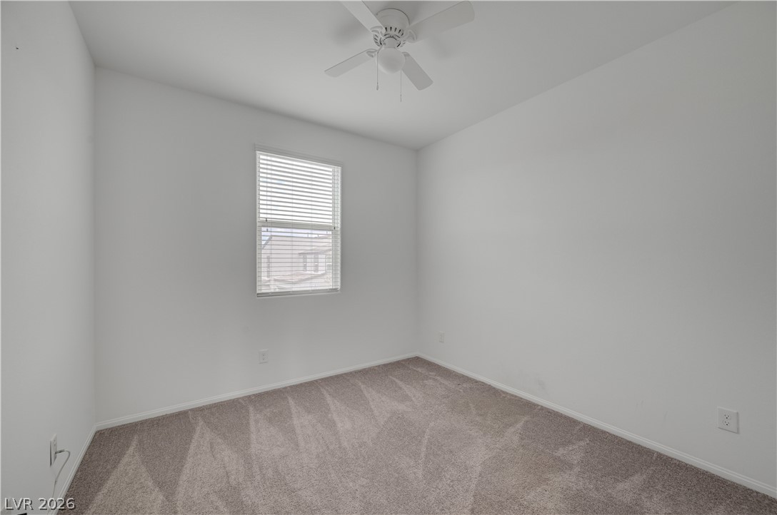 1287 Raritan Place Henderson, NV 89002 - Photo 17 of 21 A well-lit bedroom features plush carpeting and a convenient ceiling fan.