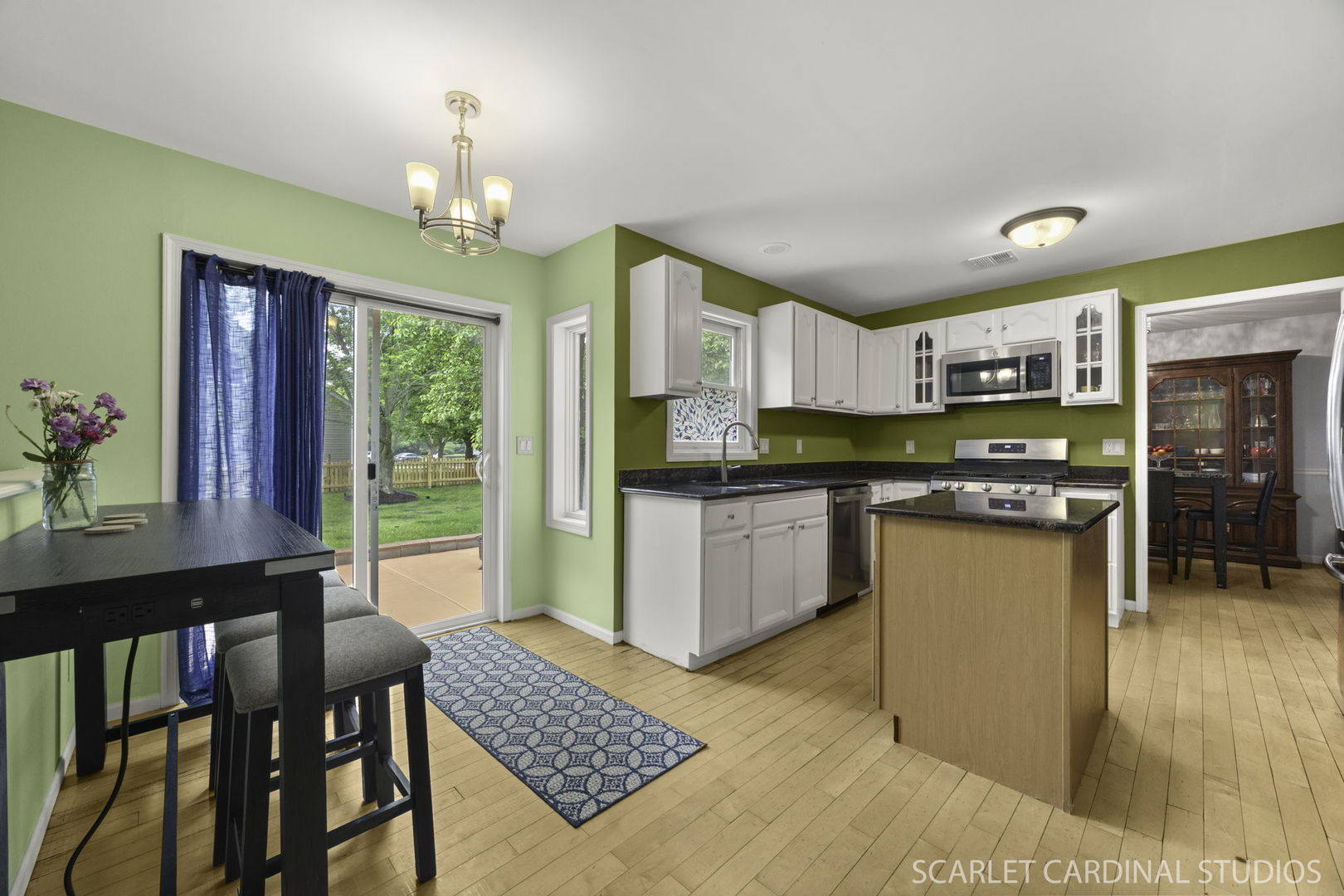 3100 Compton Road Aurora, IL 60504 - Photo 10 of 27 a kitchen with stainless steel appliances kitchen island granite countertop a refrigerator a stove top oven and a dining table with wooden floor