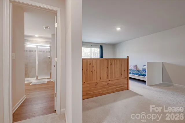 a view of hallway with stairs and a cabinet