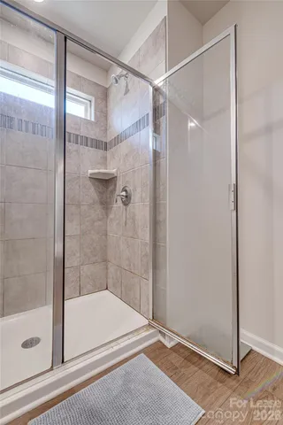 a bathroom with a shower and a bath tub