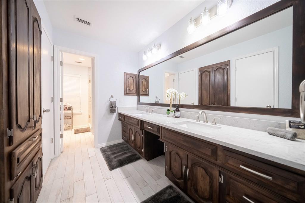 919 Green Hills Road Duncanville, TX 75137 - Photo 19 of 37 Full bathroom featuring double vanity, wood finished floors, and baseboards
