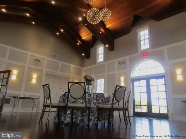a view of a dining room with furniture and chandelier