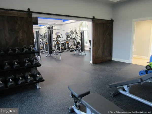 a room with gym equipment and a large window